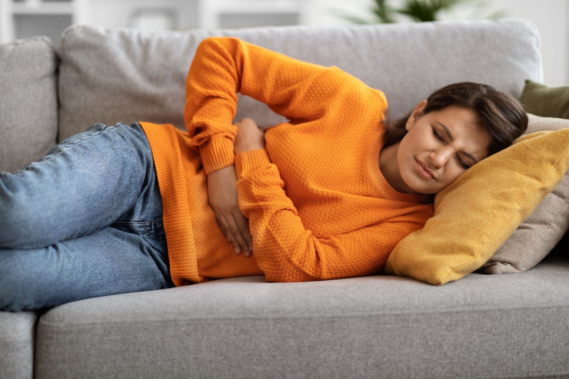 sick-indian-woman-suffering-from-stomach-ache-at-h-2023-11-27-04-51-29-utc-2