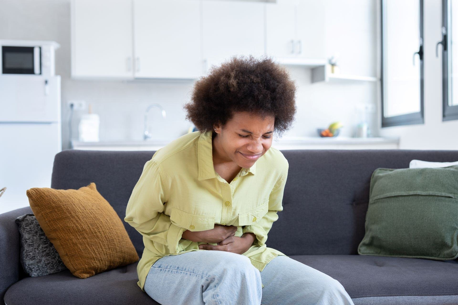sick-young-woman-in-pain-holding-belly-stomach-fee-2023-11-27-04-57-31-utc-2