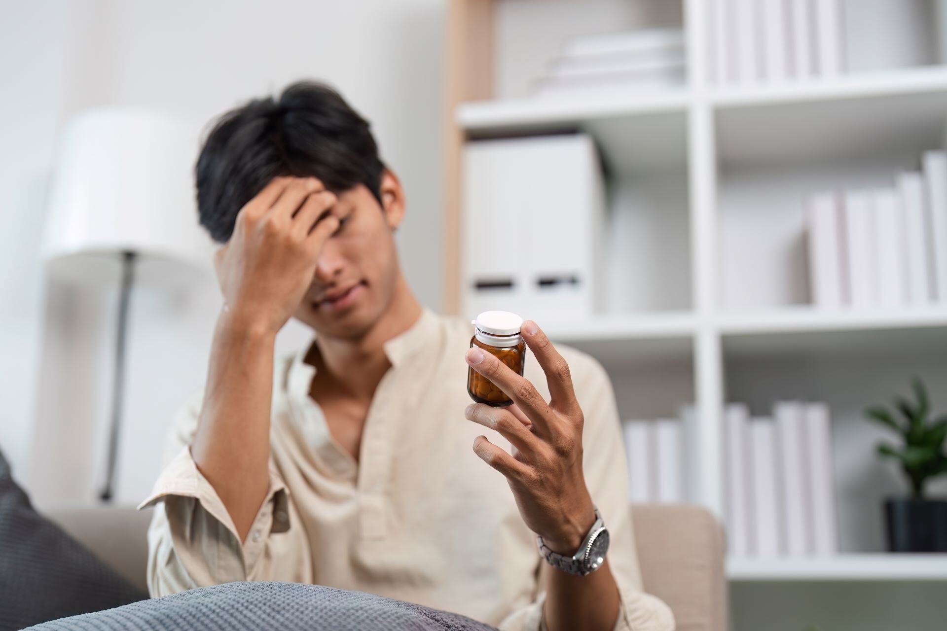 stressed-man-taking-medicine-at-home-for-anxiety-r-2024-07-19-17-57-51-utc-1